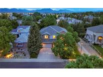 Beautiful two-story home featuring lush landscaping and a driveway leading to a two-car garage at 505 Orchard Dr, Louisville, CO 80027