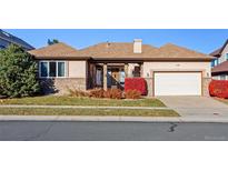 Ranch style home with attached two-car garage and manicured lawn at 486 S Youngfield Cir, Lakewood, CO 80228