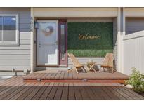 Inviting front porch with chairs, a welcome sign, and stylish decor create a warm entrance to the home at 8674 Carr Loop, Arvada, CO 80005