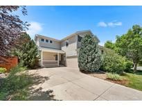 Inviting two-story home with a well-maintained lawn and a charming front porch at 11853 Trail View Ln, Parker, CO 80134
