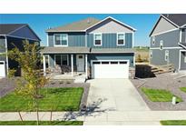 Two-story home with a gray exterior, white garage door, and landscaped lawn at 27480 E Cedar Pl, Aurora, CO 80018