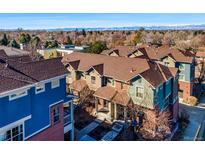 A picturesque aerial view of townhomes showcasing a charming neighborhood with mountain views in the background at 7352 E 7Th Ave # 7, Denver, CO 80230