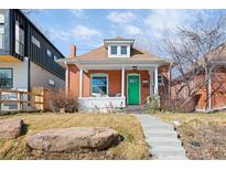 Charming brick home with a vibrant green door and inviting front porch seating area at 3419 Stuart St, Denver, CO 80212