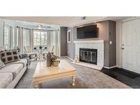 Inviting living room featuring a fireplace and cozy seating area with large bright windows at 9510 E Florida Ave # 3055, Denver, CO 80247