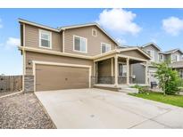 Charming two-story home with a spacious two-car garage and welcoming front porch at 47312 Lilac Ave, Bennett, CO 80102