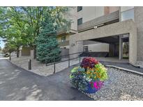 Inviting building entrance with manicured landscaping and accessible ramp for easy access at 7000 E Quincy Ave # 302, Denver, CO 80237