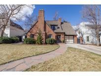 Charming brick two-story home featuring a stone walkway and attached two car garage at 629 Bellaire St, Denver, CO 80220