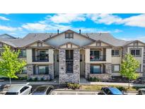Inviting two-story condo building with stone accents, private balconies, and well-maintained landscaping at 875 E 78Th Ave # 21, Denver, CO 80229