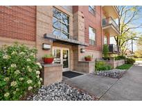 Welcoming entrance to Emerson Uptown Lofts with lush landscaping and architectural details at 1700 N Emerson St # 305, Denver, CO 80218