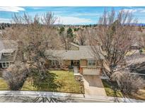 Charming ranch home with mature trees, a well-manicured lawn, and a two-car garage, blending curb appeal with comfort at 3014 E Fremont Dr, Centennial, CO 80122