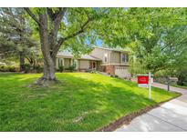 Charming two-story home with a well-manicured lawn and mature trees in a desirable location at 3014 E Fremont Dr, Centennial, CO 80122