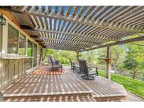 Inviting covered patio with wood pergola, comfortable seating, and views of the well-maintained backyard at 3014 E Fremont Dr, Centennial, CO 80122