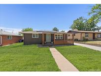 Charming single story brick home featuring a well-maintained front yard and stylish wooden porch at 1742 S Alcott St, Denver, CO 80219
