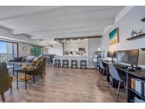 Open-concept living space with kitchen, dining, workspace, and modern finishes at 7865 E Mississippi Ave # 1006, Denver, CO 80247