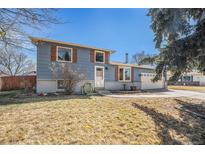 Charming two-story home features wood shutters, brick accents and an attached two car garage at 11744 W 71St Pl, Arvada, CO 80004