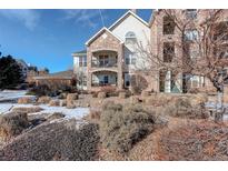 Beautiful condo building featuring stone accents and private balconies in a well-maintained community at 19049 E Warren Dr # 105, Aurora, CO 80013