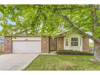 Charming single-story brick home featuring an attached two-car garage and well-maintained front lawn at 2209 S Flanders St, Aurora, CO 80013