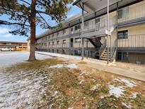 Apartment building exterior with landscaping and parking at 1723 Robb St # 31, Lakewood, CO 80215