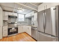 Efficient kitchen featuring stainless steel appliances, white cabinets, and modern countertops at 2607 E 14Th Ave, Denver, CO 80206