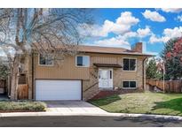Charming two-story home features a well-maintained lawn, brick accents and an attached two-car garage at 2250 S Zang Ct, Lakewood, CO 80228