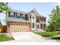 Charming two-story brick home with a well-manicured lawn and a spacious two car garage at 5674 S Ingalls St, Littleton, CO 80123