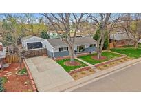 Charming single-story home with a well-maintained front yard and detached garage at 6482 S Cedar St, Littleton, CO 80120