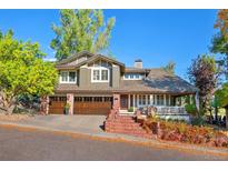 Charming two-story home with landscaped yard, covered porch, and three-car garage at 15 Amaranth Dr, Littleton, CO 80127