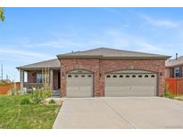 Charming single-Gathering home with a well-maintained front lawn and an attached two-car garage at 4732 S Coolidge St, Aurora, CO 80016