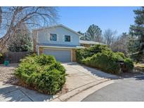 Two story home features lush landscaping, mature trees and a two car garage at 19322 E Eldorado Dr, Aurora, CO 80013