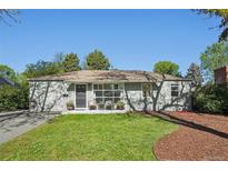 Charming single-story home with well-maintained lawn, inviting porch, and lush, mature landscaping at 1431 S Glencoe St, Denver, CO 80222