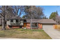 Charming brick home with a well-manicured lawn, mature trees, and inviting curb appeal at 255 Kiowa Pl, Boulder, CO 80303