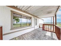 Charming covered front porch with brick pavers and lovely views of the neighboring community at 8509 Colorado Ct, Denver, CO 80229