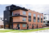 Modern brick building with multiple units and private balconies at 3408 W 17Th Ave, Denver, CO 80204