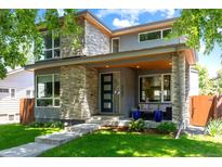 Modern home featuring stone accents, well-manicured lawn and a stylish front door at 4220 Quitman St, Denver, CO 80212
