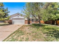 Charming single-Gathering home featuring a two-car garage and a well-maintained front yard at 12829 E Nevada Ave, Aurora, CO 80012