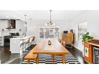 Bright dining room features dark wood floors, a modern light fixture, and a striped rug at 4270 Irving St, Denver, CO 80211