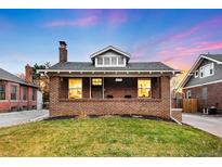 Charming brick home with a well-manicured lawn and driveway at 4270 Irving St, Denver, CO 80211