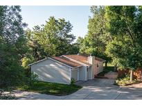 Charming single-story home with a well-maintained lawn and mature trees, offering a serene and private setting at 6396 Twin Lakes Rd, Boulder, CO 80301