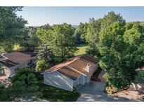 Charming single-story home featuring a well-maintained lawn, mature trees, and a spacious driveway at 6396 Twin Lakes Rd, Boulder, CO 80301