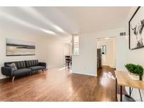 Bright living room featuring hardwood floors, modern furnishings, and great natural light at 6396 Twin Lakes Rd, Boulder, CO 80301