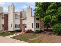 Charming two-story townhouse with brick accents and a well-maintained front yard for sale at 8126 Gray Ct # 499, Arvada, CO 80003