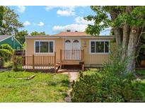 Charming single-story home with a cozy front deck, double doors, and well-maintained lawn at 1175 Xanthia, Denver, CO 80220