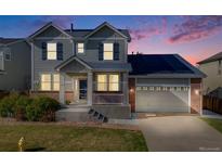 Charming two-story home features a well-manicured lawn, inviting porch, and attached garage at 7961 E 131St Ave, Thornton, CO 80602
