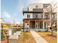 Modern three-story townhome with a covered porch and landscaped front yard at 4222 Stuart St, Denver, CO 80212