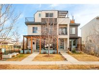 Modern three-story home with a front yard and landscaped walkway at 4222 Stuart St, Denver, CO 80212