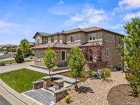 Stunning exterior showcasing architectural details, manicured landscaping, and a welcoming entrance at 10757 Timberdash Ave, Highlands Ranch, CO 80126