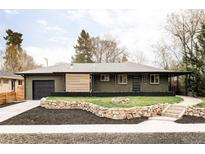 Charming single-story home with a landscaped front yard and a brick exterior at 1330 Olive St, Denver, CO 80220