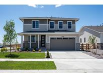 Inviting two-story home with a manicured lawn and attached two-car garage at 24790 E 39Th Ave, Aurora, CO 80019