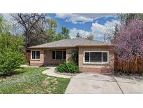 Charming brick home with a well-manicured lawn and inviting walkway, perfect for suburban living at 3031 W 20Th Ave, Denver, CO 80211