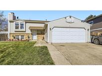 Charming two-story home featuring a two-car garage, landscaped front yard, and inviting entrance at 12425 Bellaire Dr, Thornton, CO 80241